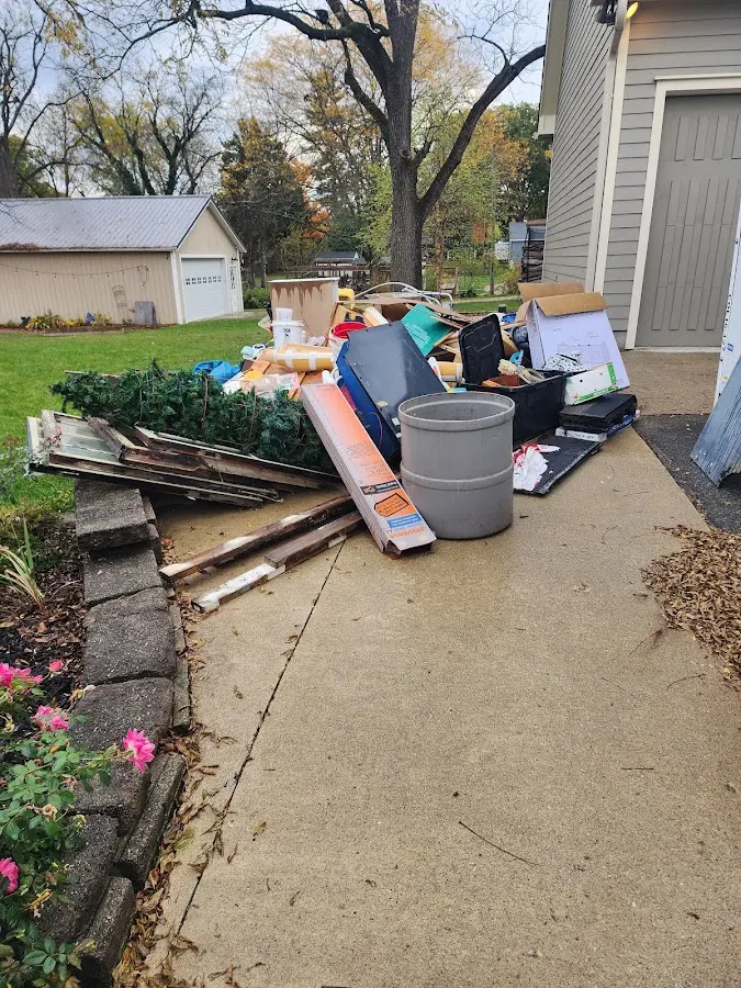Dumpster being loaded with debris for Estate Cleanout Dumpster Rental in Butner